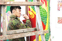 北指部三位弟兄,將原本七零八落的牆面塗上色彩。(圖/文:李羿興)