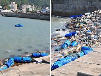遭到颱風侵襲毀損的清水澳口攔截索,建設局昨天下午僱請兩位潛水人員下水將毀損及脫離的攔截索全數收回岸上;不少斷裂部位一截一截隨著海漂垃圾一起直接湧到岸邊消波塊上,確實影響觀瞻。(圖/文:曹重偉)