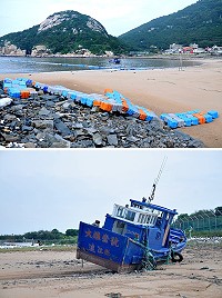 馬鼻灣簡易浮排走道受損待修,另有一艘漁船未做好防颱遭大浪沖至岸邊傾斜進水。(圖/文:陳鵬雄)