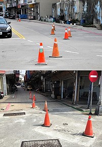 　地區從去年初即針對「機車殺手」人孔蓋進行改善，施工業者豎立三角錐提醒來往車輛注意。（圖／文：曹重偉）