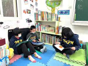 　新北市板橋國小退休教師李聰任捐贈萬冊圖書，小朋友迫不及待將書上架及閱讀。（圖：教育處）