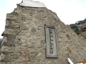 　芹壁南面山入口一民宅拆除重建，牆上的戰地精神標語將要保留。（圖／文：陳鵬雄）