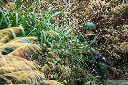官兵結合現地環境,尋找隱掩蔽位置。(圖:青年日報)