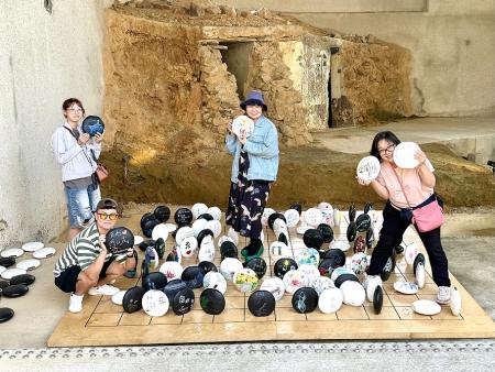 A先生在《行吧行吧，依哥依爸》景片前開心合影留念；方樺子則透過《不是誰的棋子，我們是…》，獲得對丈夫離世的深刻生命感悟。（圖／文：王致潔）