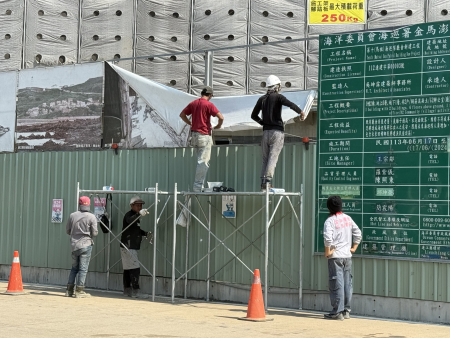 白海豚颱風逼近，環資局同仁進行道路水溝與陰井清淤；工地工人也趕緊將帆布捲起捆紮，公私部門皆全力進行防颱整備。（圖／文：王致潔）