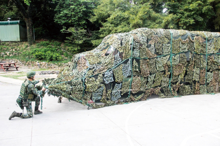 官兵實施車輛偽裝作業，強化裝備隱蔽效果。