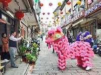 　初一賀喜，馬港街頭響起鑼鼓聲，中正國中舞獅隊向鄉親拜年，家戶回贈紅包，討個好彩頭。（圖：周柏延）