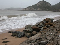 　「龍王」過境，塘后沙灘海沙回復，準備回填基礎的塊石已無用。（圖／文：陳鵬雄）